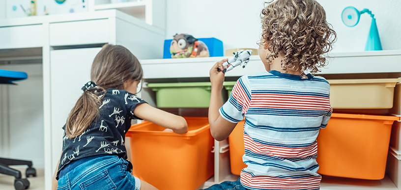 Two young children in a playroom